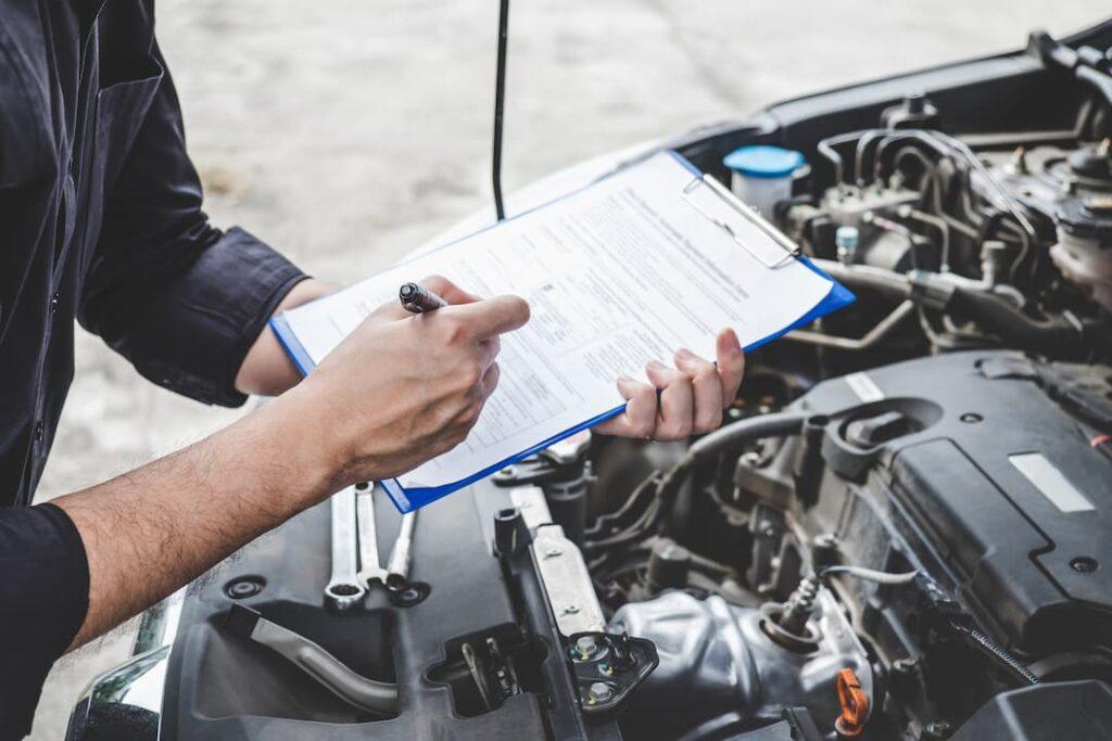 mechanic servicing a car for car maintenance