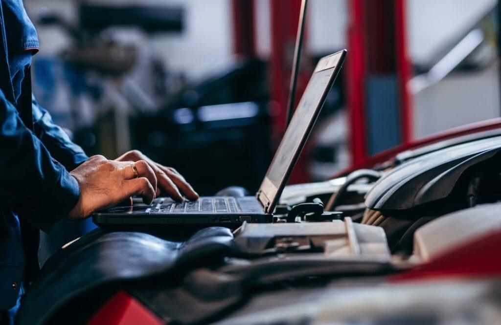 mechanic preforming a car diagnostic test